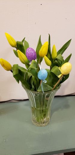 Close-up of yellow tulips in vase on table
