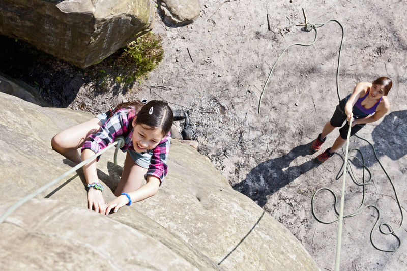 Teenage girl climbing at harrisons rock close to tunbridge wells
