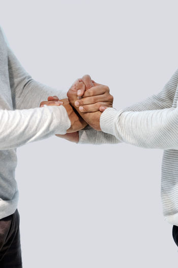 Two dancing boys hold hands facing each other