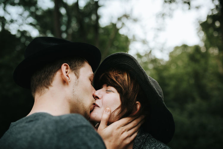 Portrait of couple kissing against blurred background