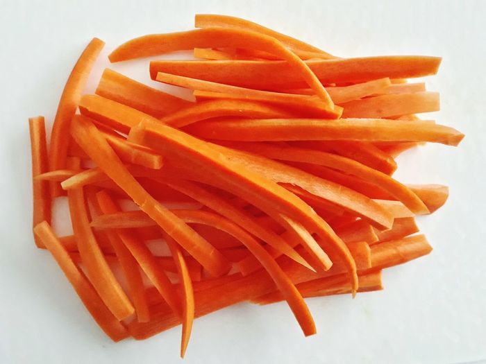 High angle view of orange slices on plate against white background