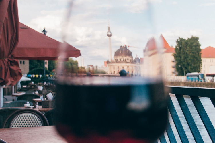 Fernsehturm and berlin cathedral seen through wineglass