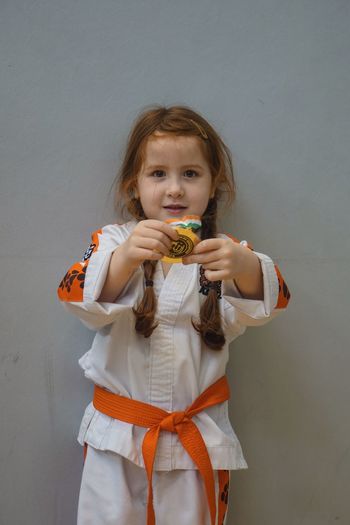 Portrait of girl holding medal 