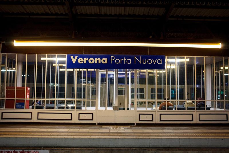 Text on railroad station platform at night