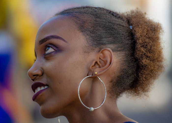 Close-up of thoughtful young woman wearing earring