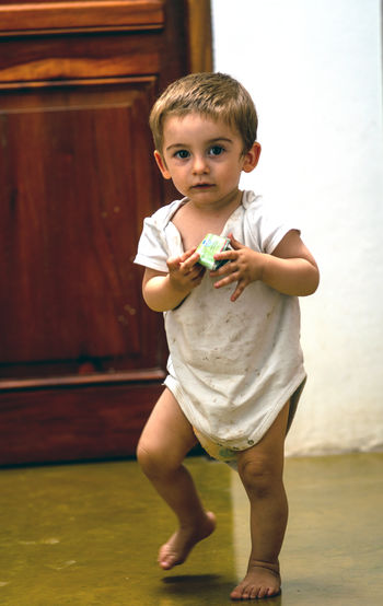 Male child walking inside his home