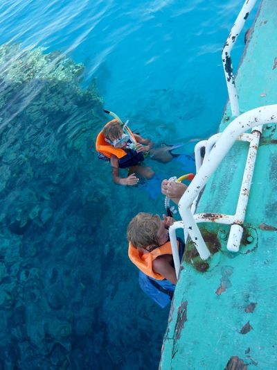 High angle view of boys snorkeling in sea