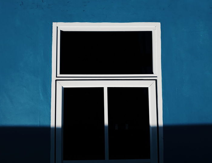 Close-up of window on blue wall
