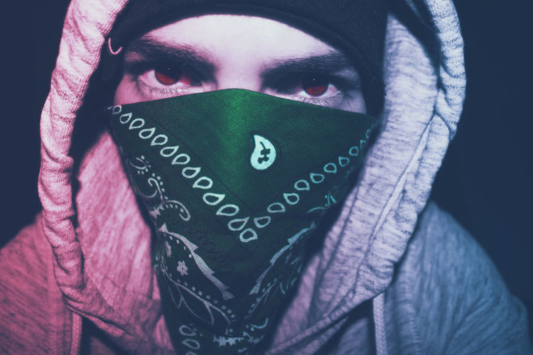 Close-up of young man wearing hood and scarf
