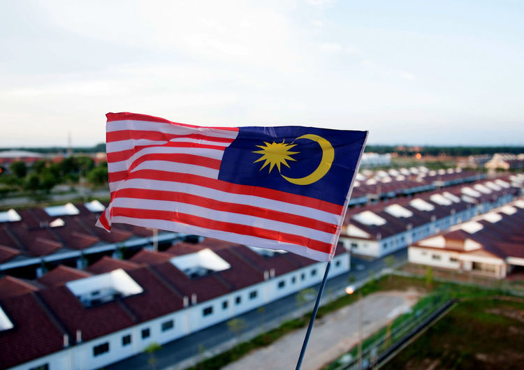 Close-up of malaysian flag against the sky