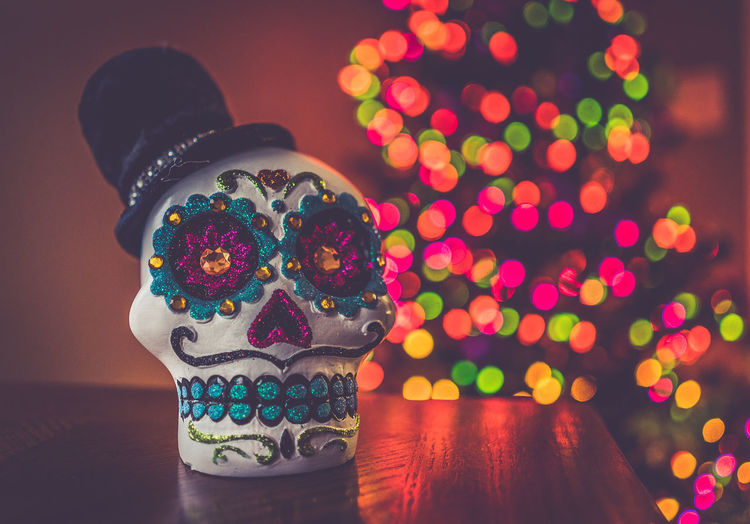 Close-up of decorated artificial skull on table
