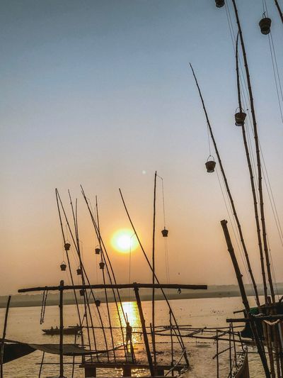 Silhouette sailboats on sea against sky during sunset