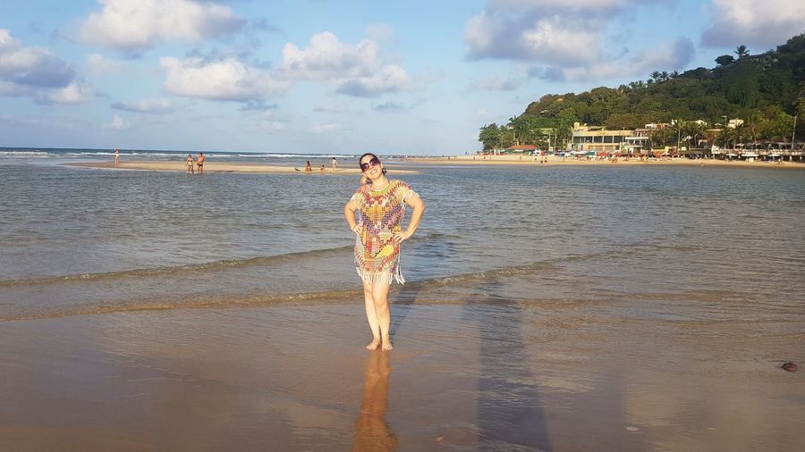 Man standing on beach against sky