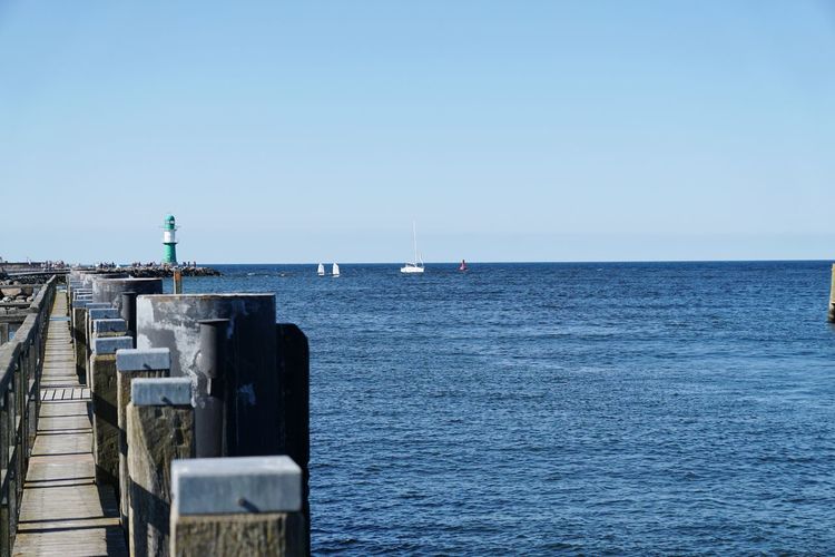 Scenic view of sea against clear blue sky