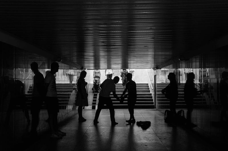 Silhouette people in underground walkway
