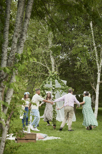 Rear view of woman standing in forest