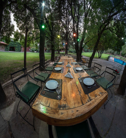 Empty chairs and table in park
