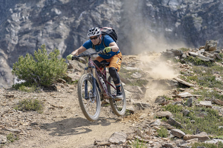 Cyclist riding bicycle on mountain