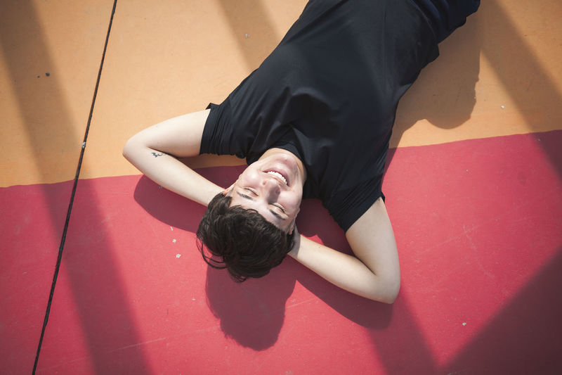 Young woman lying on colorful ground