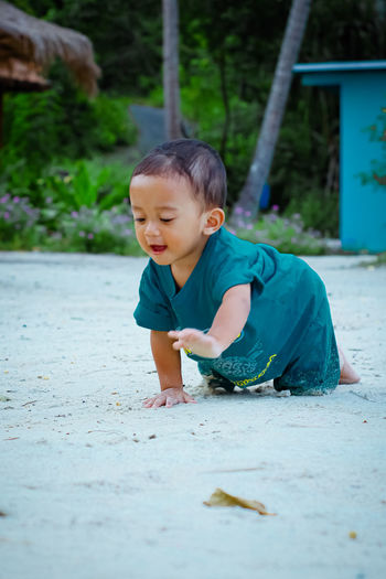 Cute boy playing on shore