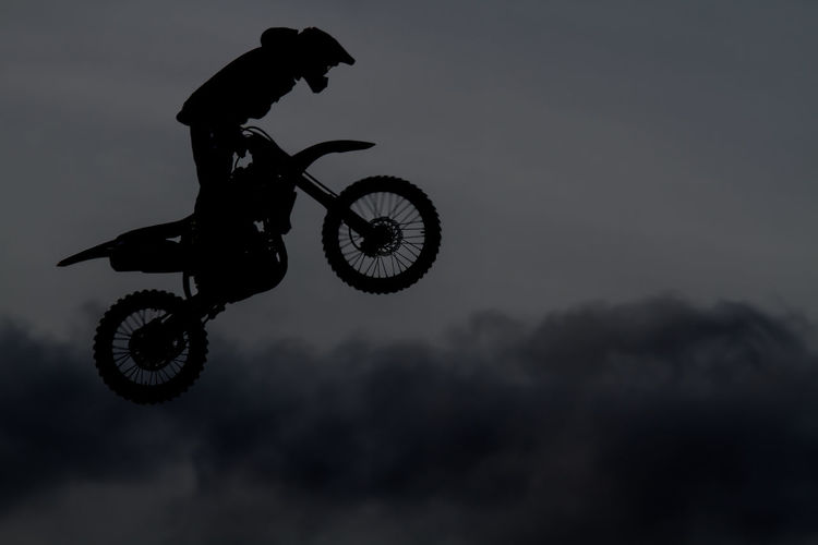 Side view of motocross racer performing mid-air stunt