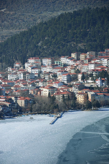 View of small port in frozen lake from the hill of prophet elias in kastoria , greece