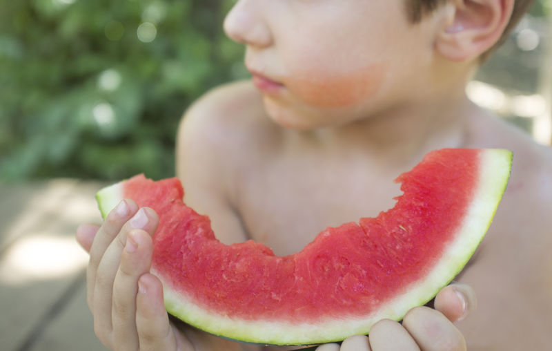 Close-up of boy holding fruits