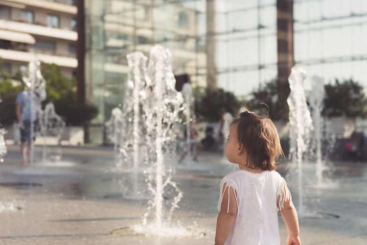 Girl standing by fountain
