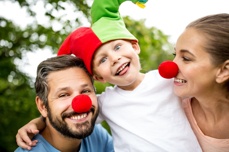 Close-up of smiling family wearing clown
