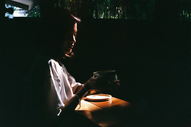 Low angle view of woman sipping tea