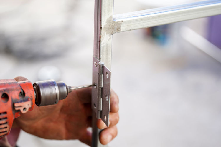 Close-up of hand working in factory