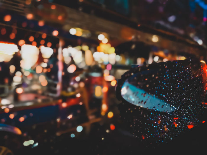 Close-up of illuminated lights in car during rainy season