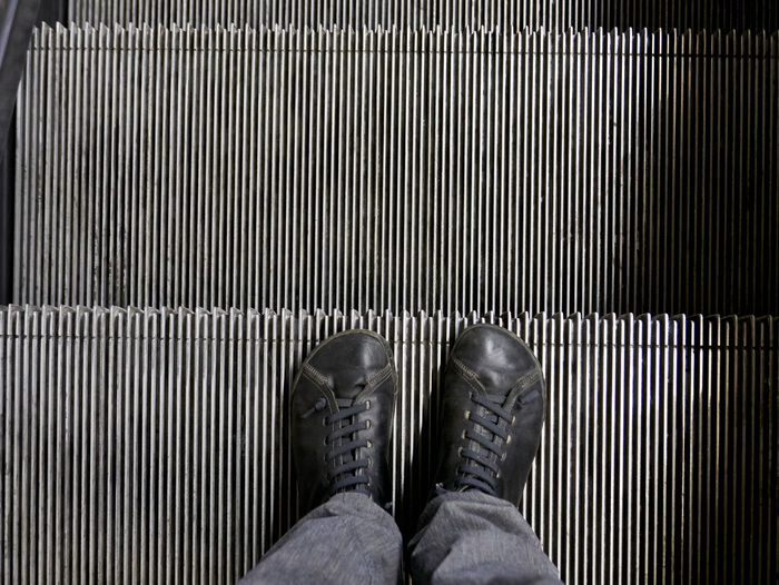 Low section of person on escalator