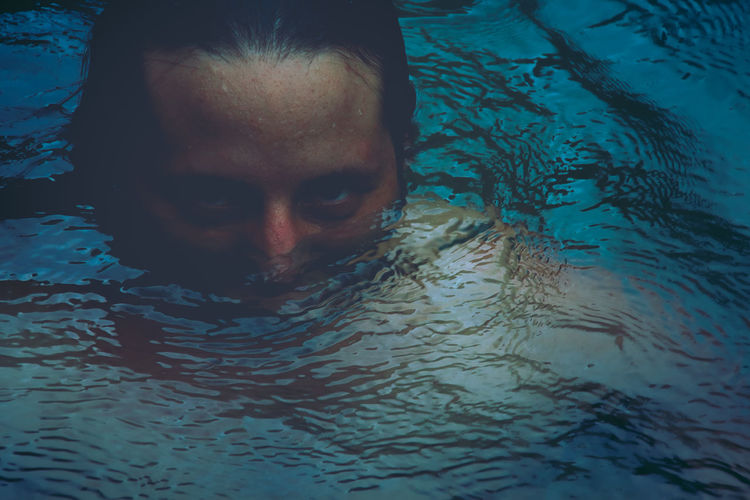Striking portraiture of half submerged male face