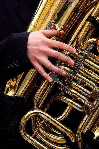 Midsection of man playing tuba