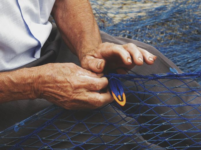 Midsection of fisherman with net