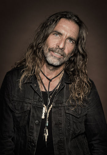 Portrait of mature man against black background