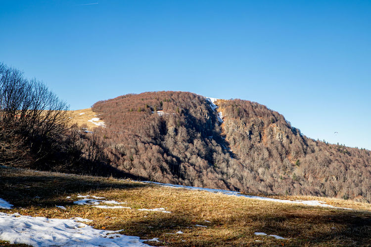 Scenic view of mountains against clear blue sky