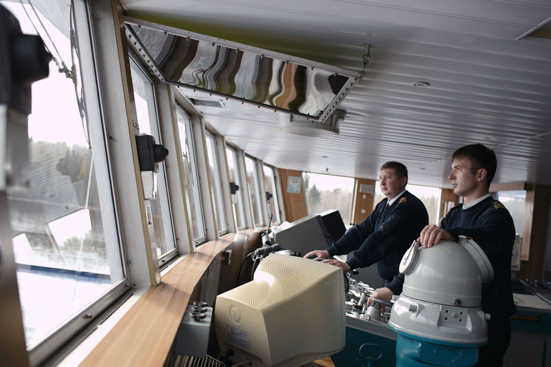 Two men driving boat 