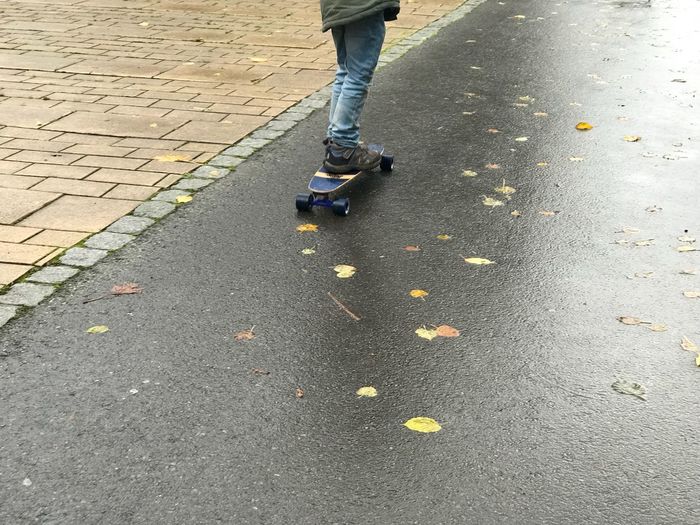 Low section of man walking on street