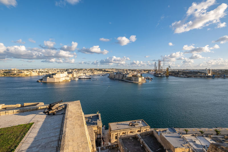 High angle view over valetta grand harbour against cloudy sky