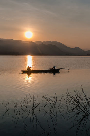 Scenic view of lake against sky during sunset