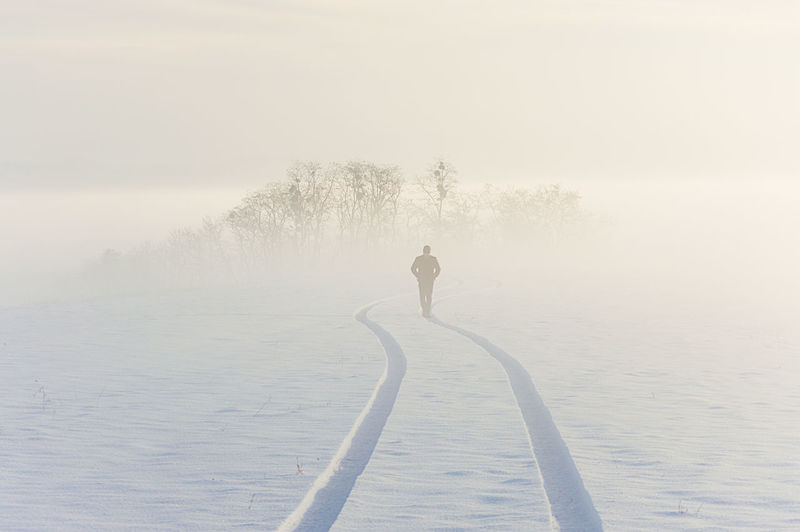 Teenager walking on snow against sky