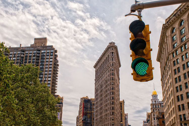 Low angle view of buildings against sky in ny traffic light