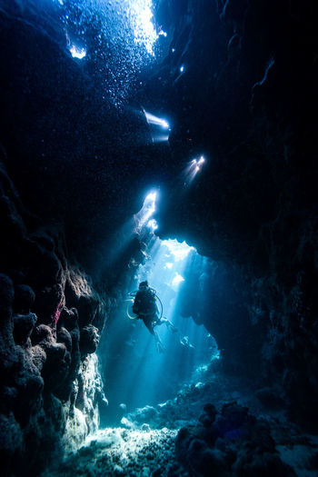 Scuba diver amidst rocks in red sea