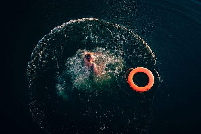 Woman with inflatable ring swimming in sea