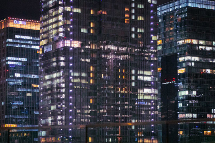 Low angle view of illuminated buildings in city at night