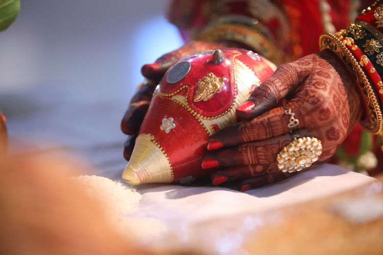 Cropped hands of woman during traditional ceremony