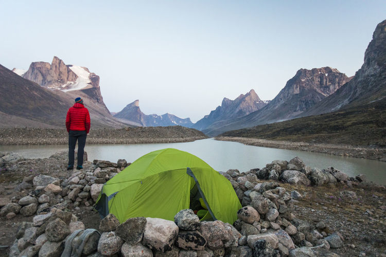 Climber enjoys view of summit lake from his campsite in akshayak pass