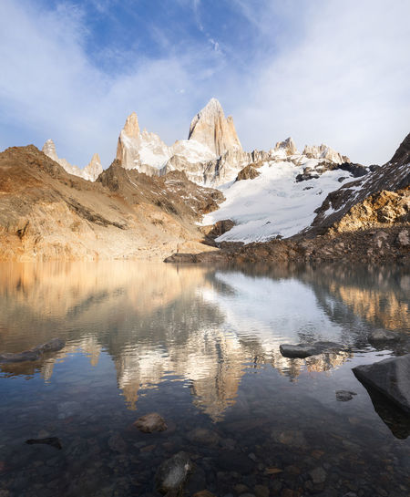 Scenic view of lake and snowcapped mountains against sky